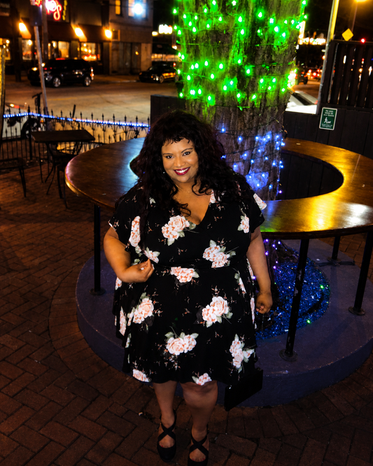 Size 4x (26) Torrid black floral smocked georgette dress with a v-neck and tiered skirt.