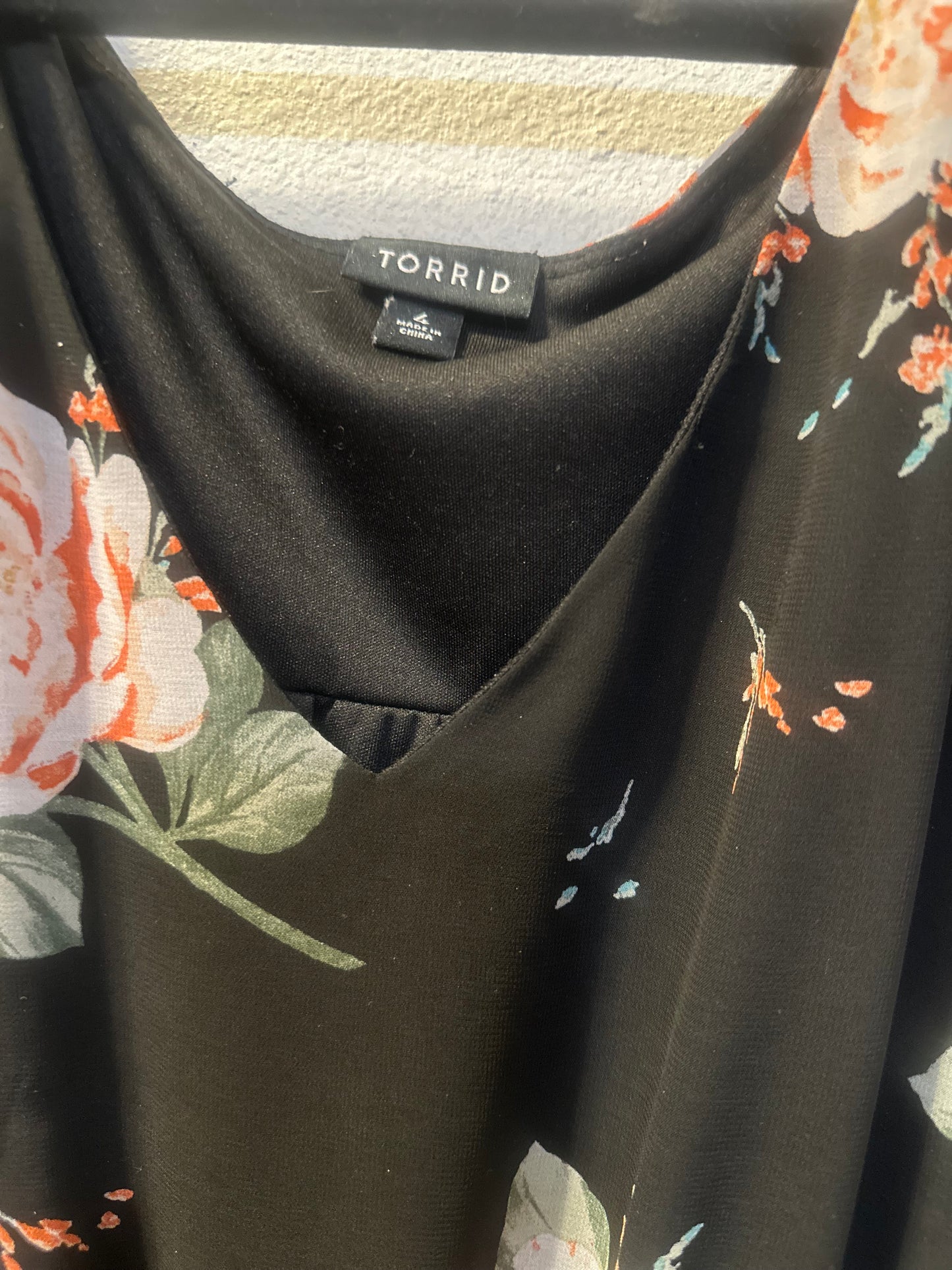 Size 4x (26) Torrid black floral smocked georgette dress with a v-neck and tiered skirt.