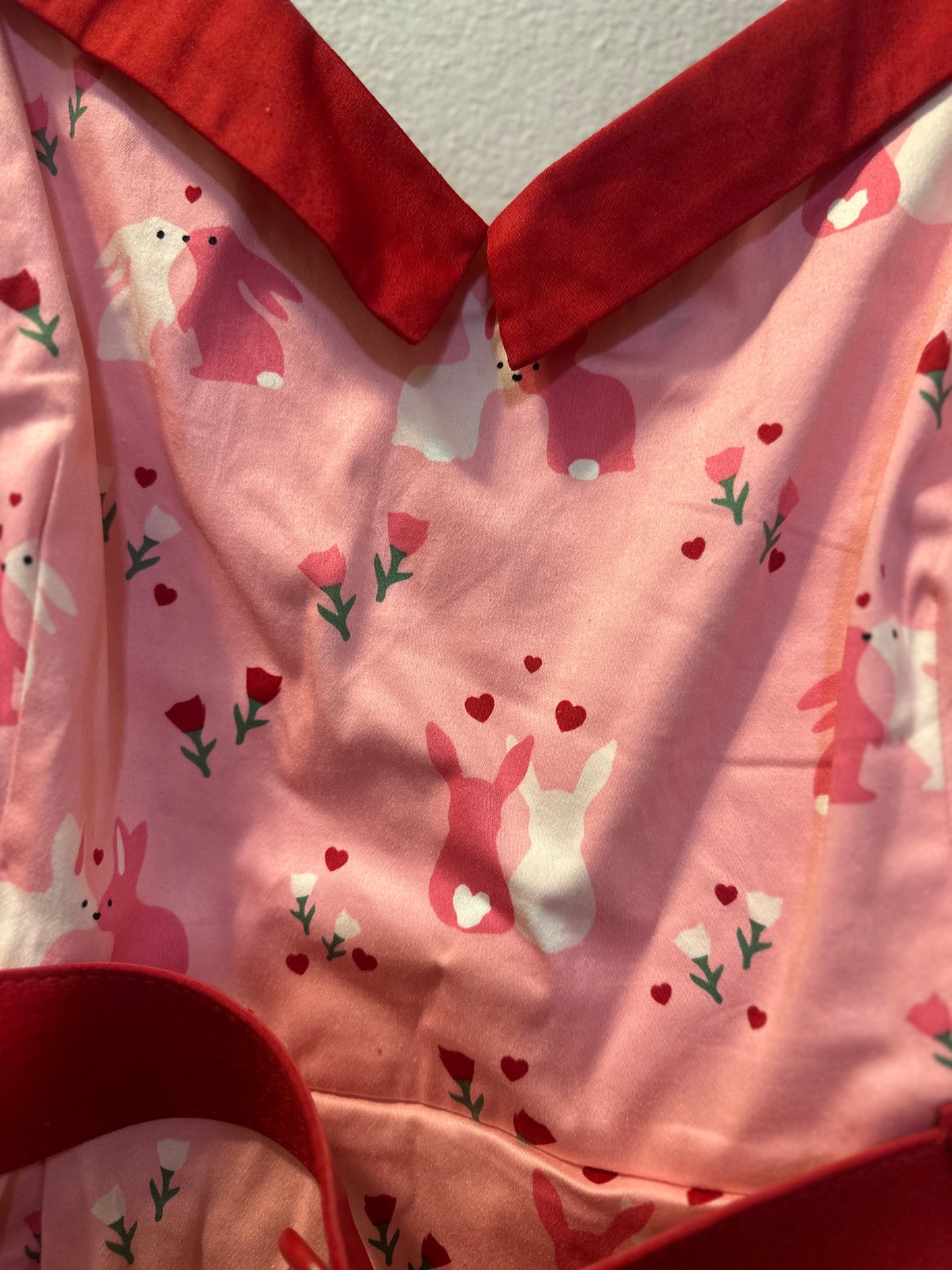 Size 4x (26) Collectif Nova Some Bunny To Love Dress featuring a pastel pink bunny and floral print.