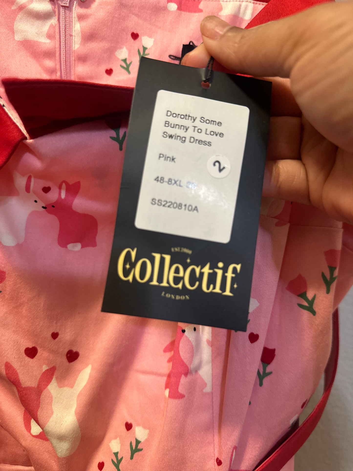 Size 4x (26) Collectif Nova Some Bunny To Love Dress featuring a pastel pink bunny and floral print.