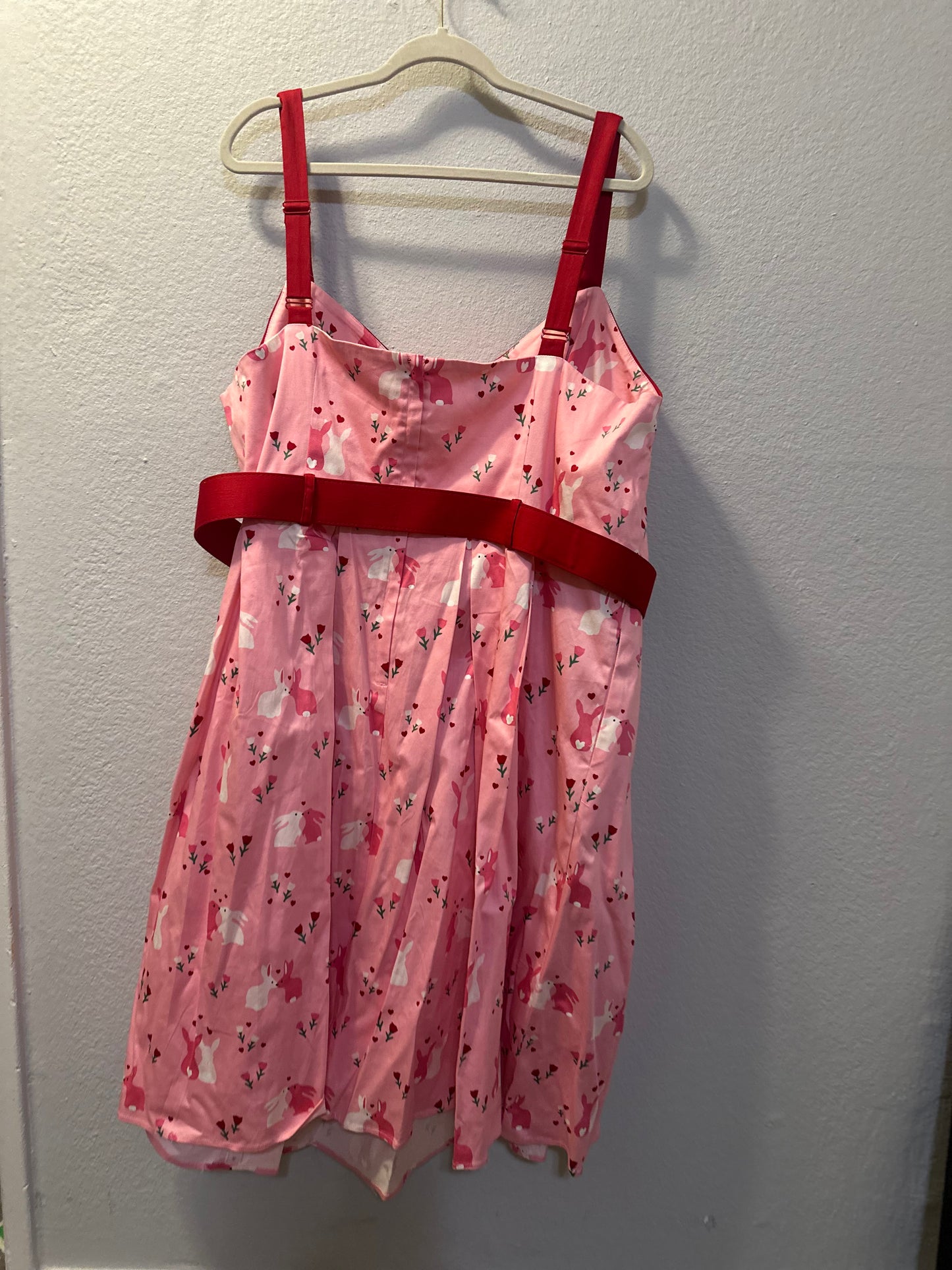 Size 4x (26) Collectif Nova Some Bunny To Love Dress featuring a pastel pink bunny and floral print.